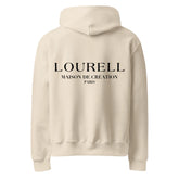 Rückansicht des sandfarbenen Unisex Oversize-Kapuzenpullovers, der den großen, schwarzen Rückenprint 'LOURELL MAISON DE CRÉATION PARIS' zeigt.